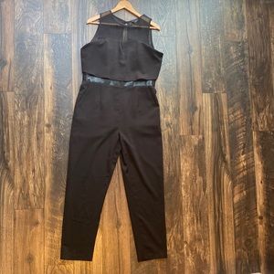 Black jumpsuit with sheer details and pockets